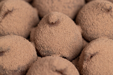 a large number of sweet candies in chocolate powder