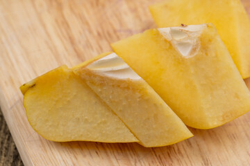 Sliced ripe yellow quince on a cutting board