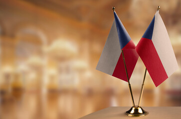 Small flags of the Czechia on an abstract blurry background