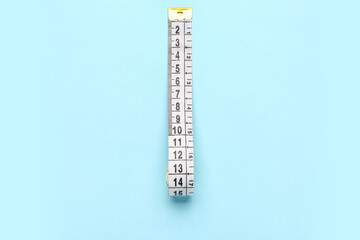 White measuring tape on blue background