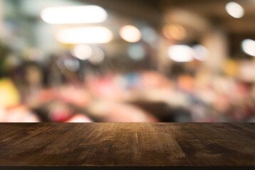 Empty wooden table in front of abstract blurred background of coffee shop . can be used for display Mock up  of product