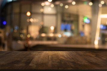 Empty wooden table in front of abstract blurred background of coffee shop . can be used for display Mock up  of product