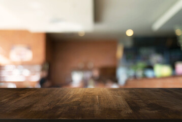 Empty wooden table in front of abstract blurred background of coffee shop . can be used for display Mock up  of product