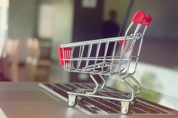 Small shopping cart with Laptop for shopping online concept