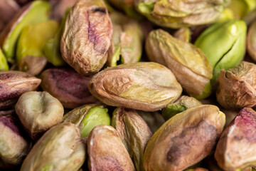 Crispy delicious pistachios with salt on the table