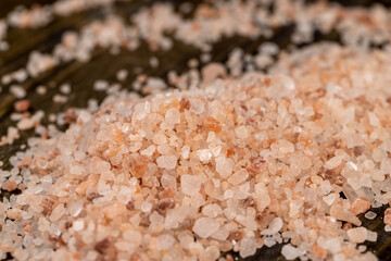 Pink natural salt on the table, close up