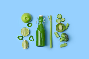 Glass bottle of tasty green juice and ingredients on blue background