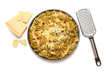 Plate of tasty Italian pasta with Parmesan cheese and grater on white background