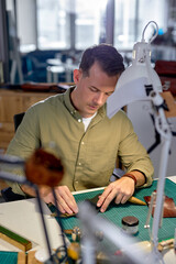 young man cleaning and conditioning natural material. close up portrait.guy loosens and removes dust, dirt, debris, and grime from the leather surface.