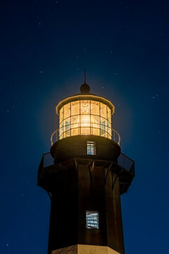 Close up of the Tybee Island Light Station at night with stars in the background.  Image taken at blue hour.