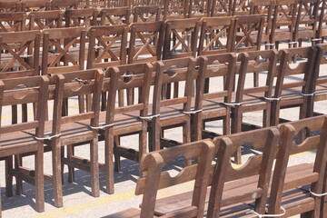 Wooden chairs and tables in a row for meeting participants, Alanya, Turkey, April 2023.