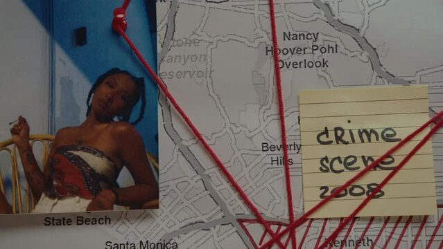 Photo of victim, sticky note, map pinned to investigation board and linked with red thread. CSI, criminology concepts. Close-up shot