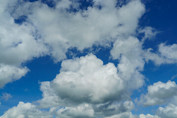 Naklejka na ściany i meble Fluffy clouds in the blue sky. Cloudscape