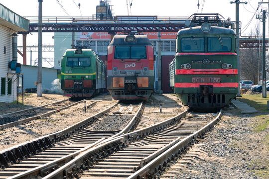 VOLKHOV, RUSSIA - APRIL 17, 2023: Three Russian electric locomotives at the building of the locomotive depot on the  Volkhovstroy 1 station