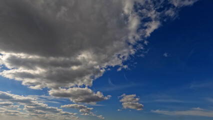 Fototapeta na wymiar nebulosity rare nice white cumulus clouds in the summertime sky - photo of nature