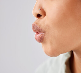 Pout, lips and woman face whistle with her mouth or kiss with lipstick or gloss isolated in a white...
