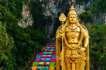 The Batu Caves Lord Murugan Statue and entrance near Kuala Lumpur Malaysia. A limestone outcrop located just north of Kuala Lumpur, Batu Caves has three main caves featuring temples and Hindu shrines.