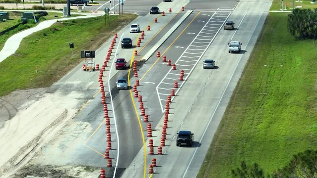 Construction roadworks on american transport infrastructure. Renovation of highway road with moving traffic. Development of interstate transportation concept