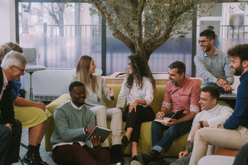 Multiracial group of creative people brainstorming in modern co working space