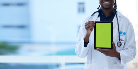 Doctor, happy man and hands with green screen on tablet in telehealth, healthcare or life insurance at hospital. Hand of male medical professional holding technology with mockup or copy space display