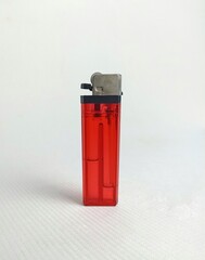 red lighter on whiite background. lighter transparent oil tank