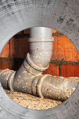 Sewer pipes in home basement. System of gray sanitary pipes when building a house. Sewer...