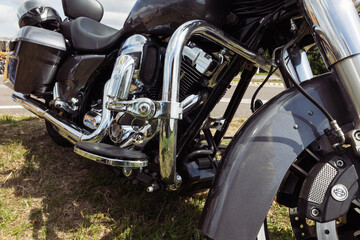 Fototapeta na wymiar black motorcycle side view close-up ,motorcycle standing on green grass isolated,close-up view