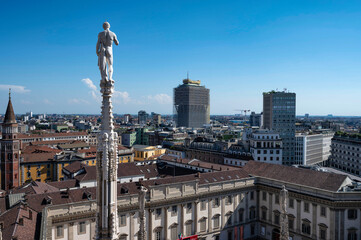 Fototapeta na wymiar Rooftop of Duomo di Milano or Milan Cathedral with spires and statues