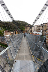 Fototapeta premium Suspension bridge, for the passage of people, and cross the Narcea river in Cangas del Narcea, Asturias, Spain