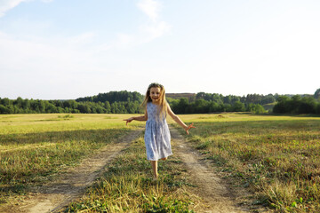 Children walk in the summer in nature. Child on a sunny spring morning in the park. Traveling with children.