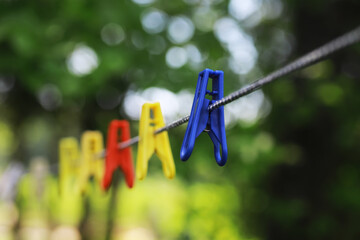 Clothespins on a clothesline in summer. Dry clothes outside. Clothes on a rope.