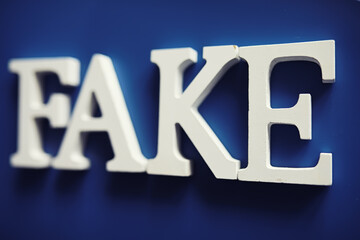 The letters spelled the word fake. The concept of modern information technology. Fake and facts in the news.