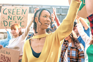Hispanic woman incites crowd during a protest against global warming - Group of young people...
