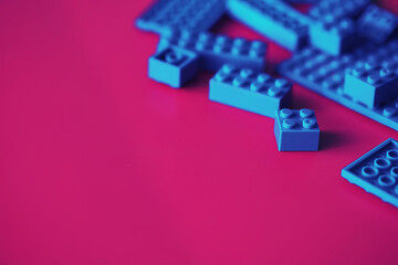 A scattering of constructor elements for children. Colored blue bricks from the puzzle.