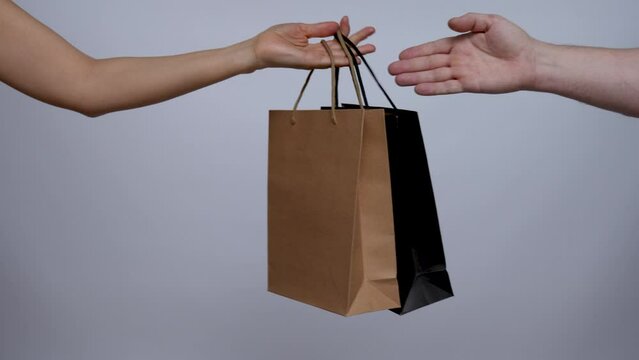 Close up of woman hands receive a shooping bag