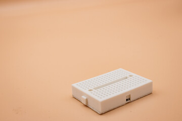 White mini breadboard isolated on background. Close up.