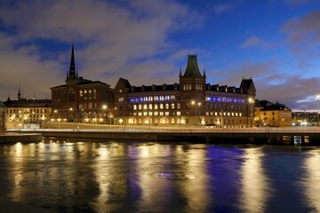 Fototapeta na wymiar Beautiful panorama of illuminated Stockholm by night, waterfront view. Sweden