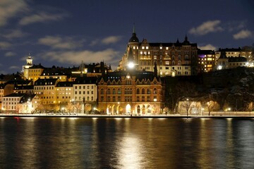 Beautiful scenery of illuminated Stockholm waterfront view towards Sodermalm district with historic Mariahissen building and Monteliusvagen, Sweden	