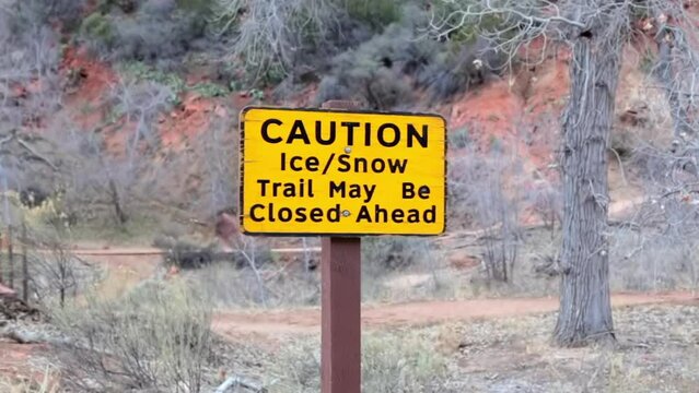 Caution "ice and snow" sign in Zion National Park during winter, USA