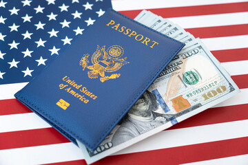 US American passport and money dollars on flag background. purchase of citizenship concept, work in...