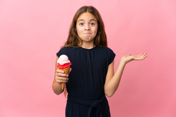 Child with a cornet ice cream over isolated pink background having doubts while raising hands