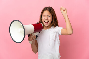 Child over isolated pink background shouting through a megaphone to announce something