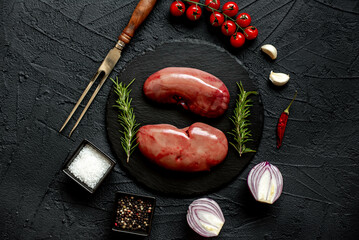 raw pork kidneys on stone background