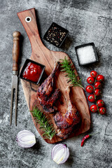 grilled duck legs on a stone background