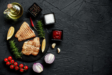 grilled pangasius white fish fillet with spices on a stone background  with copy space for your text