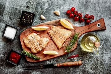 grilled pangasius white fish fillet with spices on a stone background 