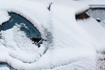 Park cars covered with snow. close-up