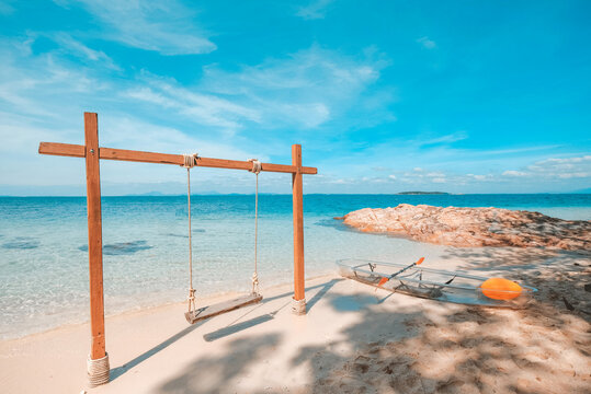 Swings and kayaks by the sea, white sand beach, beautiful romantic view at Koh mun nork ,Thailand
