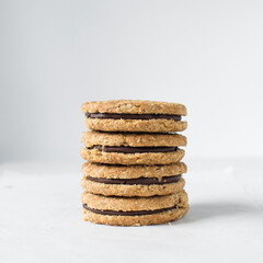 oat cookies with chocolate filling, homemade oatmeal cookies filled with chocolate ganache, thin oat biscuits with chocolate ganache