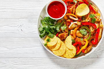 chicken fajitas with peppers, onion, taco chips